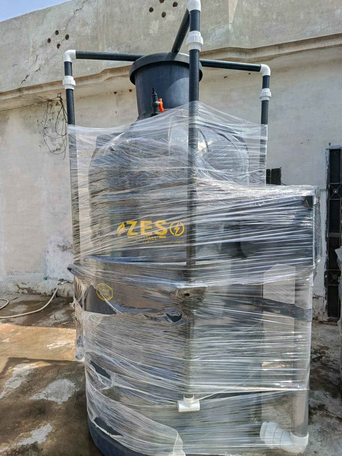 A finished ZES unit, still wrapped, showing the moulded tank and inlet box